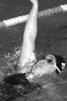 Rebecca Savoia performs a backstroke for the womens swimming team Friday against Pasadena City College.