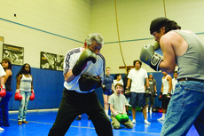 Boxing instructor Mitsura Yamashita teaches his class the basics of boxing with his assistant Jeffrey Nakamura. Yamashita was instructing his class on how to bob and weave while instructing students