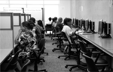 Students take advantage of the computers provided by the Writing Center to work on class assignments.