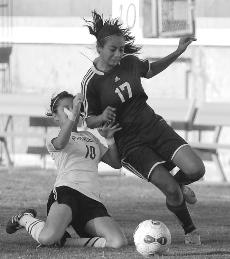 El Camino striker Natalie Soto is shooken up a bit by Pasadena's defense. The Warriors overcame various obstacles, and were able to walk away with a 3-1 victory against the Pasadena Lancers Friday Nov. 6, 2009.