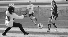 KayC Wharton scores against the Pasadena City College keeper last year. Wharton plays multiple sports at EC.