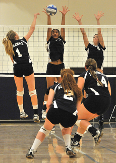 Kaye Lani Tanuvasa (middle), setter, prevents a L.A. Harbor point in the teams 20th win of the season last Friday.