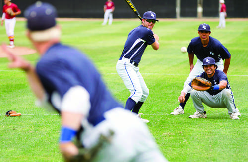 Prior to the game on the road at Pasadena City College, players are seen having some fun as shortstop Atley Shwabb delivers the pitch as teamates, Luke Klocek batter, Umpire Trinidad Loeza, and catcher Marvin Flores wait with excitement.   The Warriors co