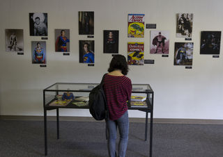 Rosa Garcia, Culinary Arts, 18, looks at one of the many superhero displays at the school library.