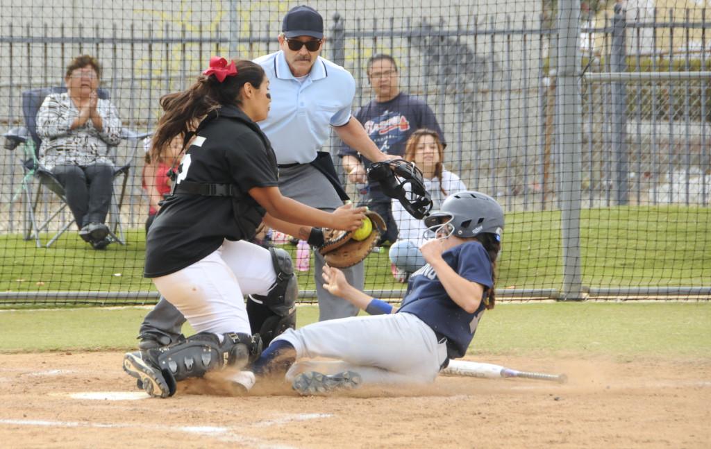 Freshman Kathy Orozco, slides into home, she was later ruled out. The Warriors went on to defeat EC Compton Center 7-6 last Saturday. Photo credit: Amira Petrus