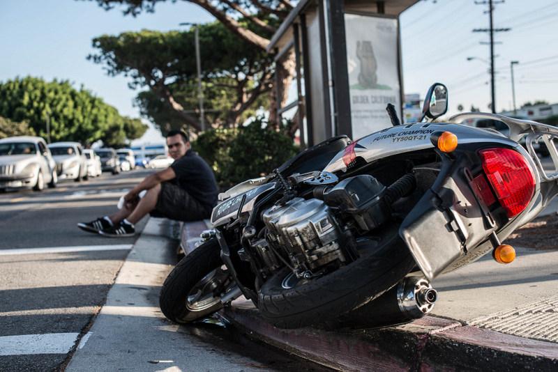 Marco Montes, 26, was nearly struck on his scooter around 7:15 Monday morning by a student driving her car northbound on Crenshaw Boulevard as Montes was going southbound. Photo credit: Patricklee Hamilton