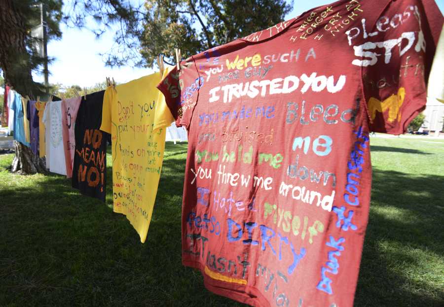 T-shirts with messages from victims of domestic violence, hang on a clothing line on the Library Lawn on Tuesday. The Clothesline Project Display is being hosted by the Young Womens Christian Association and encourages women to speak out against domestic violence. Photo credit: John Fordiani