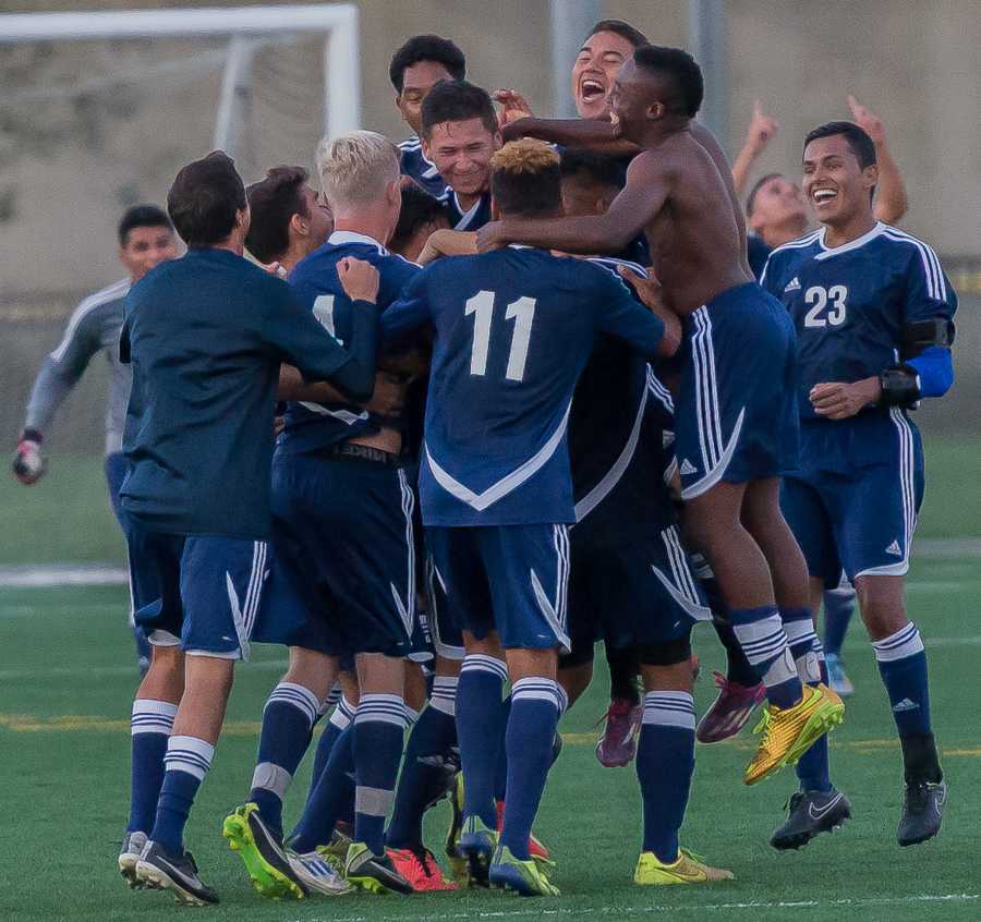 The El Camino Men’s soccer team celebrates after their dramatic, down-to-the-wire November 14th game against Cerritos College, which ended in a 1-1 tie. The result guaranteed that the Warriors finished in 1st place in the South Coast Conference, giving them a home field advantage throughout the playoffs. Photo credit: Gilberto Castro