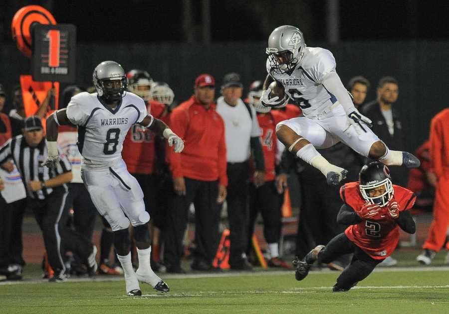 Receiver Vladimir Gray leaps over a Long Beach City College player during the Warriors’ 53-31 loss Nov. 15. Photo credit: Tristan Bellisimo