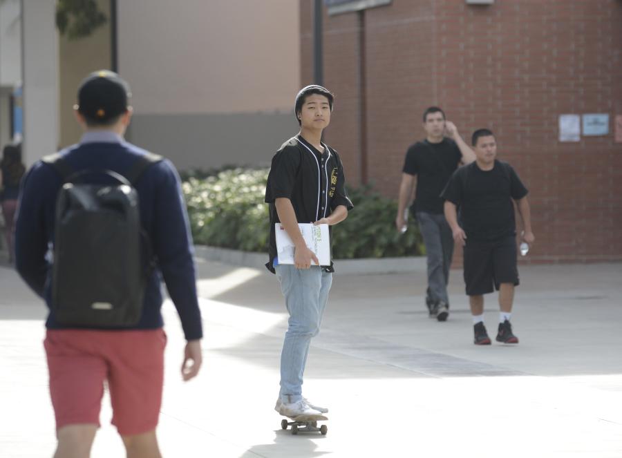 John Park, 18, undecided major, rides his skateboard through campus. Park said he doesnt see a problem with people skateboarding on campus unless they bump into people walking. Photo credit: John Fordiani