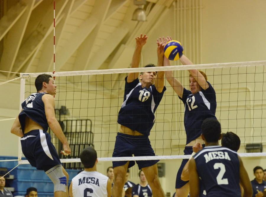 (Left) Sophomore outside hitter Casey Wood and sophomore middle blocker Peter Nordel block a hit from San Diego Mesa outside hitter Matt Stagg. The Warriors defeated the Olympians 3-0 on Wednesday night. Photo credit: John Fordiani