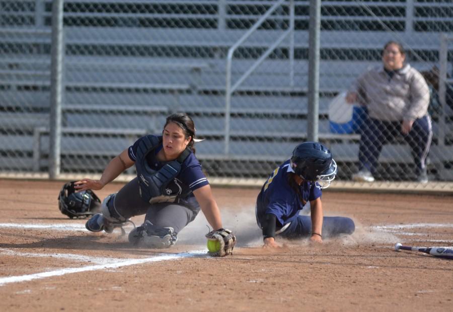 Sophomore catcher Gabby Fordiani attempts to get a San Diego Mesa player out at home base. The Warriors tied the first game 4-4 and lost the second game 6-5 in a double header against the Olympians on Friday afternoon. Photo credit: John Fordiani