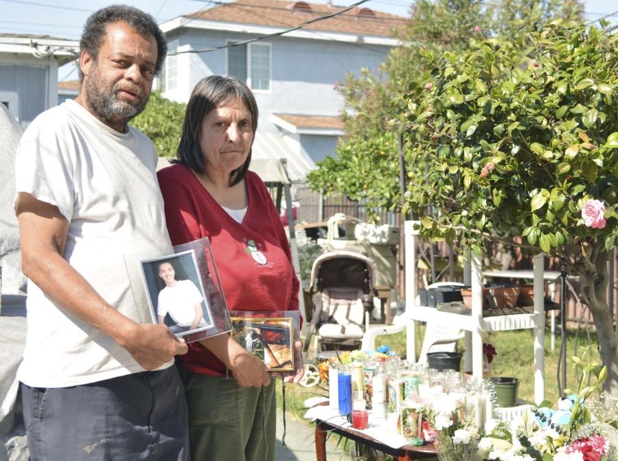 Tommy Cheatham Sr. and Christine Marie Chavez hold pictures of their son Tommy Cheatham Jr. in the backyard of their South L.A. home. Tommy Cheatham Jr., an El Camino student, was killed in the backyard of his home on the evening of April 6 by an unknown attacker. Photo credit: John Fordiani