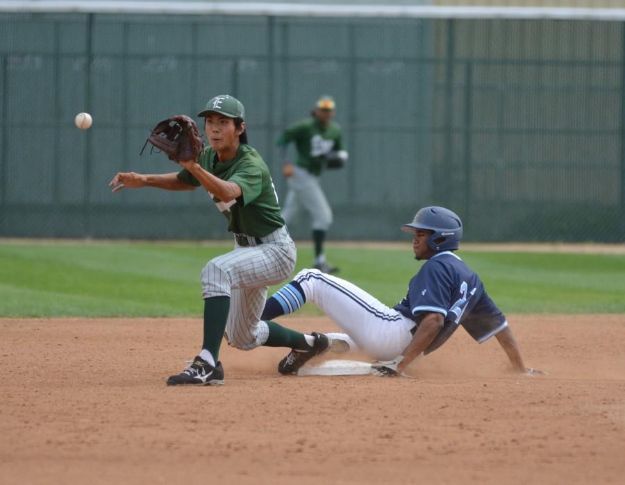 Warriors outfielder Alex Turner slides into second base just before an East Los Angeles second baseman catches the ball. The Warriors defeated the Huskies 9-6 on Tuesday. Photo credit: John Fordiani