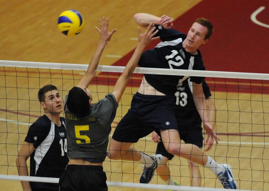 Warriors middle blocker Peter Nordel spikes the ball past Grossmont College middle blocker Andres Verjan during the third set of the state semi finals on Thursday evening. The Warriors defeated the Griffins 3-2 at San Diego City College. The Warriors will play Santa Monica College on Saturday for the state championship. Photo credit: John Fordiani