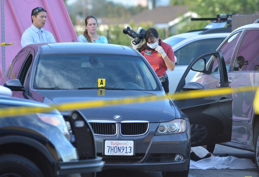Los Angeles County Sheriff investigators document the scene in the 3400 block of Crenshaw Boulevard, where an El Camino student was shot to death. Photo credit: John Fordiani