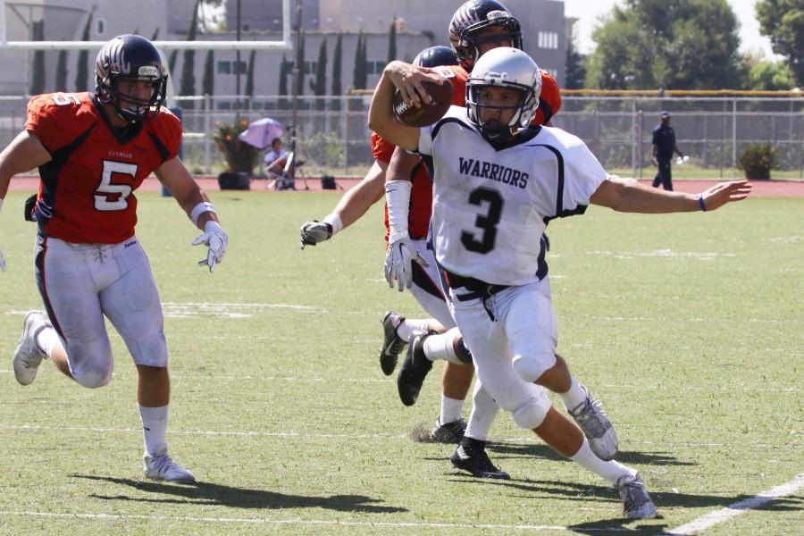 Quarterback Jorge Hernandez  makes a play with a run up field during Saturdays game at Citrus College. The Warriors defeated the Owls 23-20. Photo credit: Jackie Romano