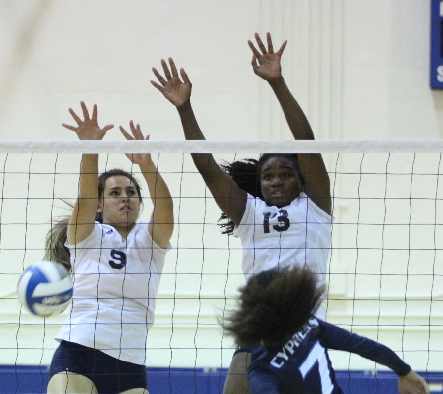 Sophomore outside hitter Nickeisha Williams and sophomore middle blocker Jewel Yandall block a spike from Cypress College player during a home game against the Cypress College Chargers on Sept. 16.