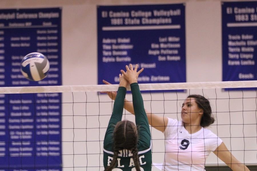 Sophomore middle blocker Jewel Yandall spikes the ball past one of the East Los Angeles College players during the home game on Friday, Oct 2. Yandall helped lead the team to a win with multiple blocks and kills. Photo credit: Jo Rankin