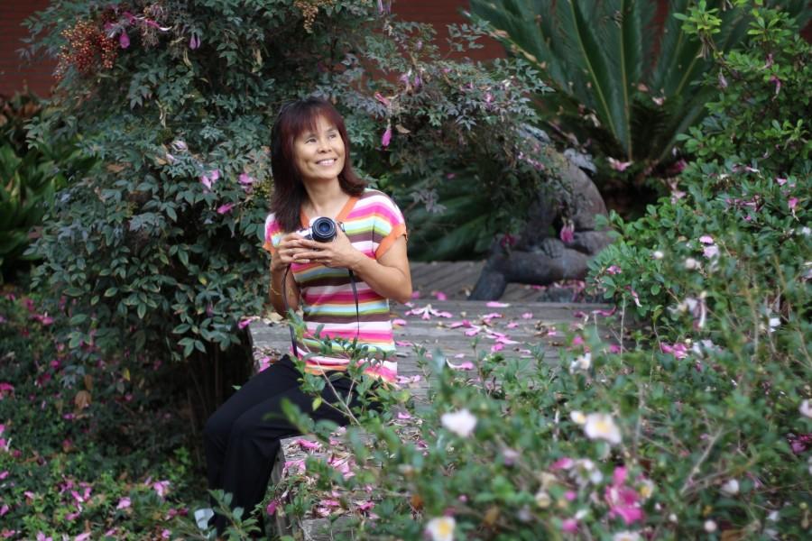 Mei Young sits in the courtyard next to the Art Gallery. Young is an advanced photographer who uses a film camera and likes to develop photos in black-and-white. Photo credit: Jo Rankin