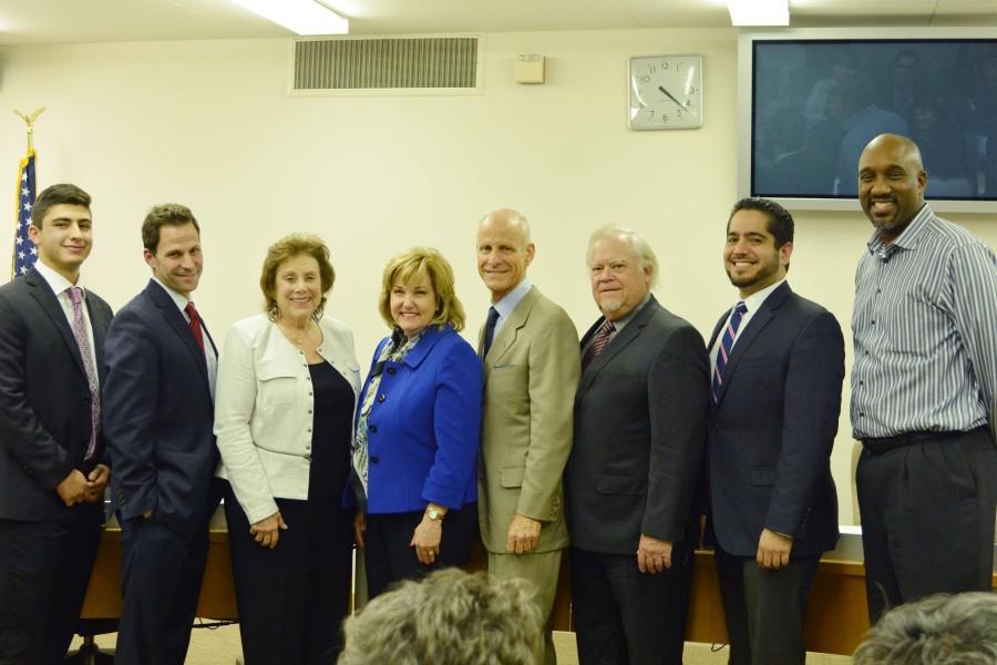 (Left) Student trustee Eman Dalili, trustee Cliff Numark, trustee Mary Combs, new president Dena Maloney, president Tom Fallo, trustee Bill Beverly, trustee John Vargas and trustee Ken Brown pose for a photo at the Nov. 16 board meeting. Maloney will be starting her new job on Feb. 1. Photo credit: John Fordiani