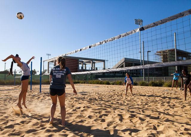 Sophomore Michelle Shimamoto (left) attacks the ball during the Feb. 8 beach volleyball practice. The Warriors look to make it to state after an 11-5 overall record and 3-2 conference record during the 2015 season. Photo credit: Jorge Villa