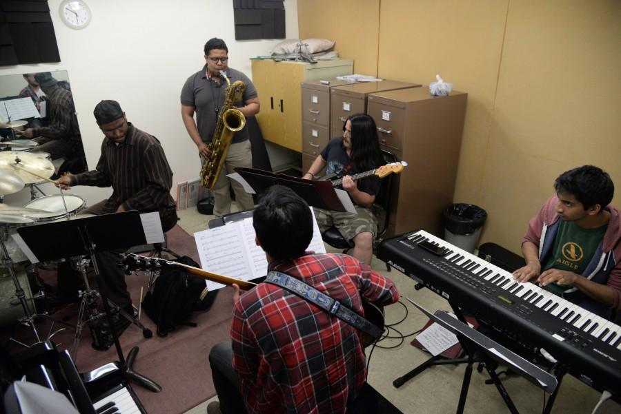 Walter Jones, 26, plays the drums, Tyler Johnson, 22, plays the saxophone, Gavin Vellems, 22, plays the bass, Srimal Del Mel, 19, plays the piano and John Aparicio, 24, plays the guitar. The band met here through the music program which they consider, one big family. Photo credit: John Fordiani
