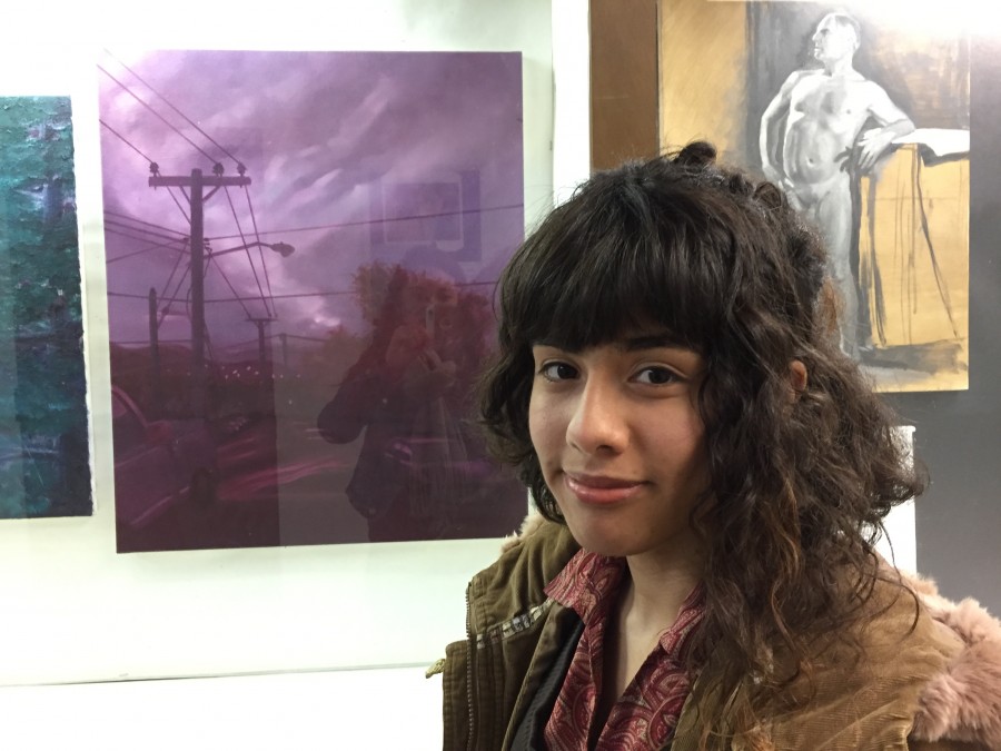 Stephanie Guerro, 21, graphic design major, stands in front of her photo displayed in the Arts Building on Thursday, March 10. Photo credit: Lauren Liddle