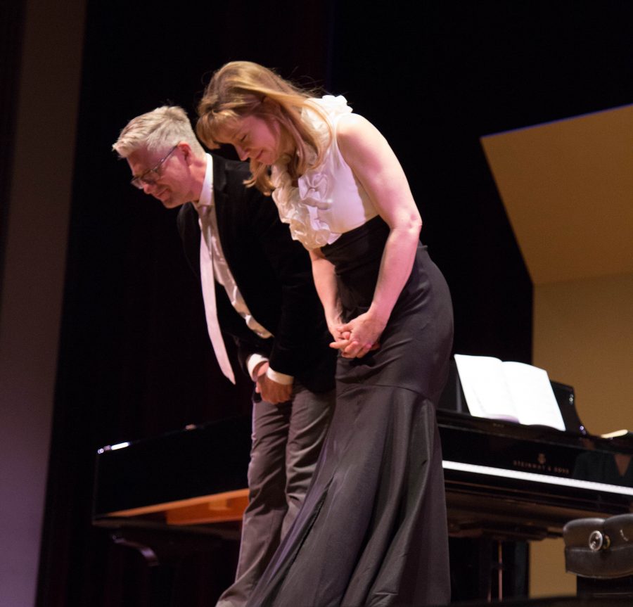 Pianists Christopher Brennan and Polli Chambers-Salazar take a bow after the performance of their last song Suite No- Russian Easter, Friday April 23 at the Marsee Auditorium. Photo credit: Gabriela Better