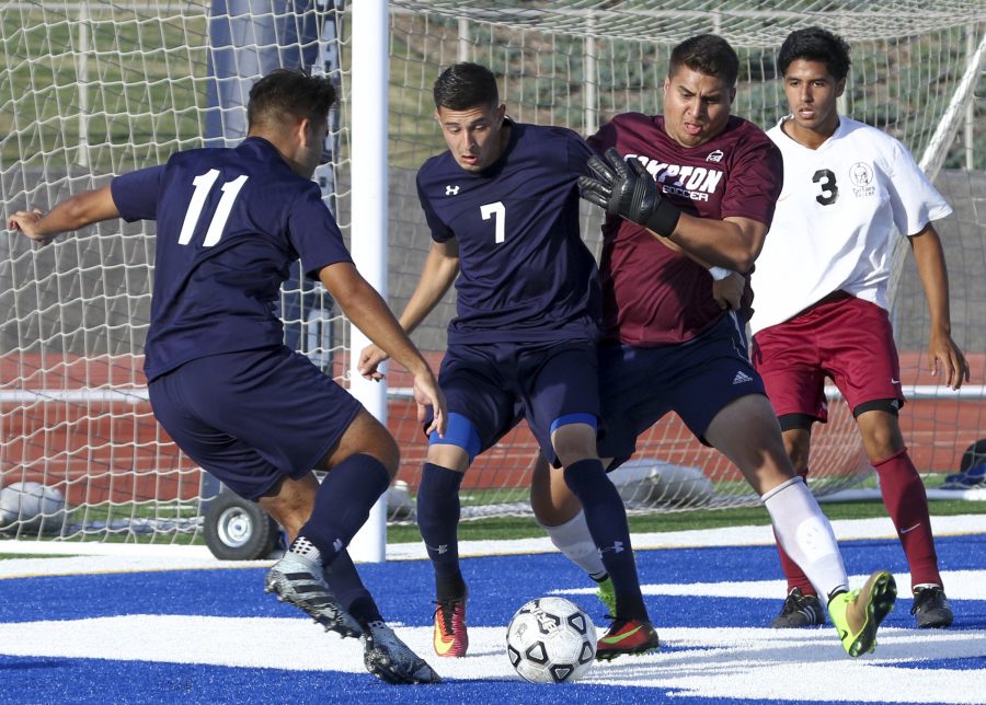 El Camino players Marcos Ambriz and Misael Serrano gaining control of the ball during Tuesday Sept. 27, game against Compton-Center at El Camino. Photo credit: Jackie Romano