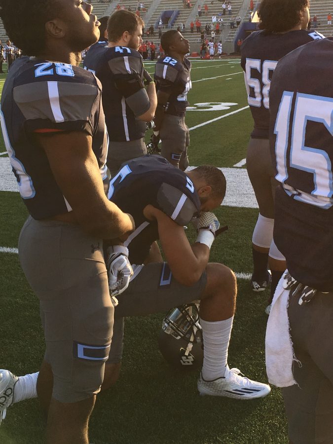 El Camino College tight end Erik Henneman gets down on one knee during the National Anthem on Oct.1 at Murdock Stadium. Photo credit: Eric Ramos