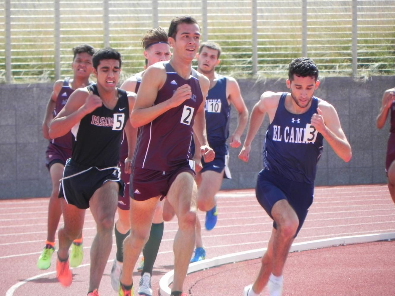 El Caminos Israel Cardona (right) begins to make his move to the front of the pack in the mens 1500 meter race at Murdock Stadium on Friday, April 28. Cardona won the event with a time of 4:05.21. Photo credit: Don Perez