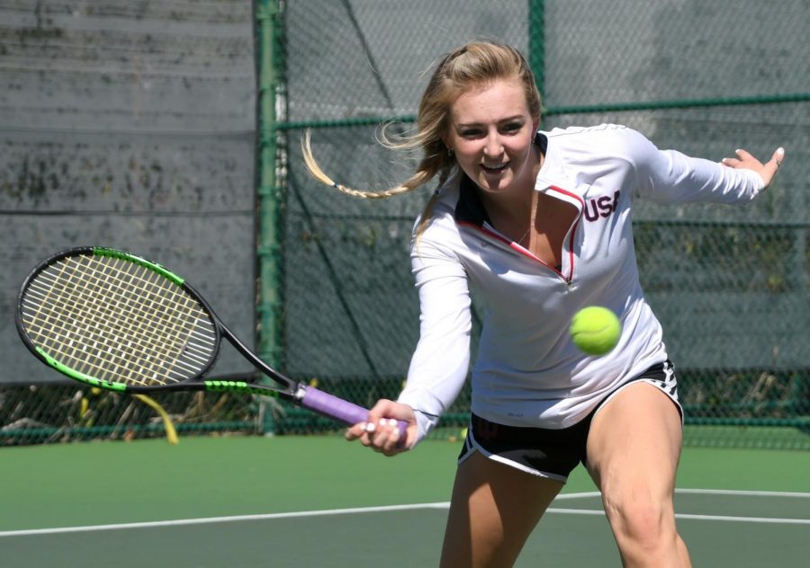 Maddie+Giese+gets+down+to+hit+a+low+slice+forehand+volley+on+Thursday%2C+March+15.+Photo+credit%3A+Jack+Kan