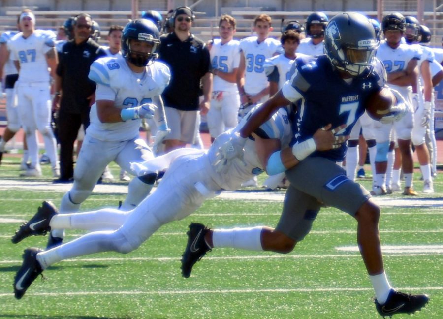 ECC wide receiver Aaron Magee (No.7) drags a Raiders defender on a 26-yard reception during the ECC vs. Moorpark College football game at Murdock Stadium on Saturday, Sept. 29, 2018. ECC won the game by the final score of 23-13. (Jack Kan/Union) Photo credit: Jack Kan