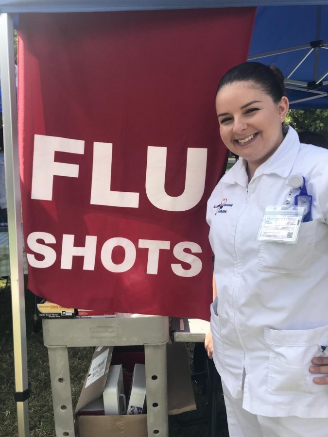 Johanna Burgos, 33, in front of the Flu Shot Clinic tent. Photo credit: Alexa Kinoshita