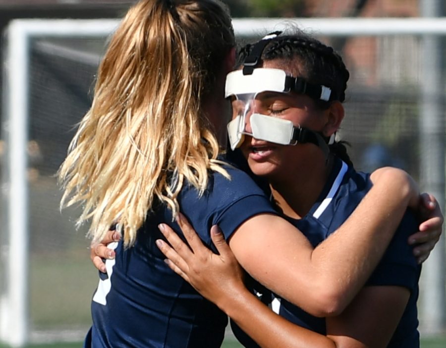 EC forward, Nalleli Mendoza (No.11) celebrates the goal she scored with an assist from Robin Riggs (No.3) against Long Beach City College at home on Friday, Oct. 26. Mendoza is wearing a mask because her nose was broken in a previous match. Photo credit: Jack Kan