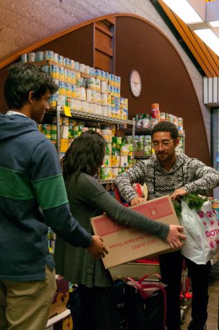 Norman Xavier, 18, Political Science, Lindsey Lee, 18, Business, and Sean Min, 20, Architecture, members from the student body help organise donations in the ASO executive office pantry.
