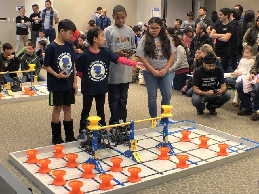 Two teammates from the Al Wooten Jr Youth Center team competing with a team from the Steam Bot Workshop. Feb. 17, 2019. Photo credit: Jaime Solis