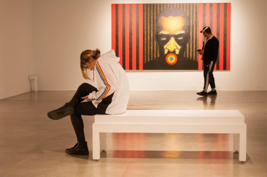A student sits in front of a Frank J Williams art piece which is a representation of his health throughout the years. This was taken in the “Personal Truth” exhibit in the EC art gallery. Photo credit: Elena Perez