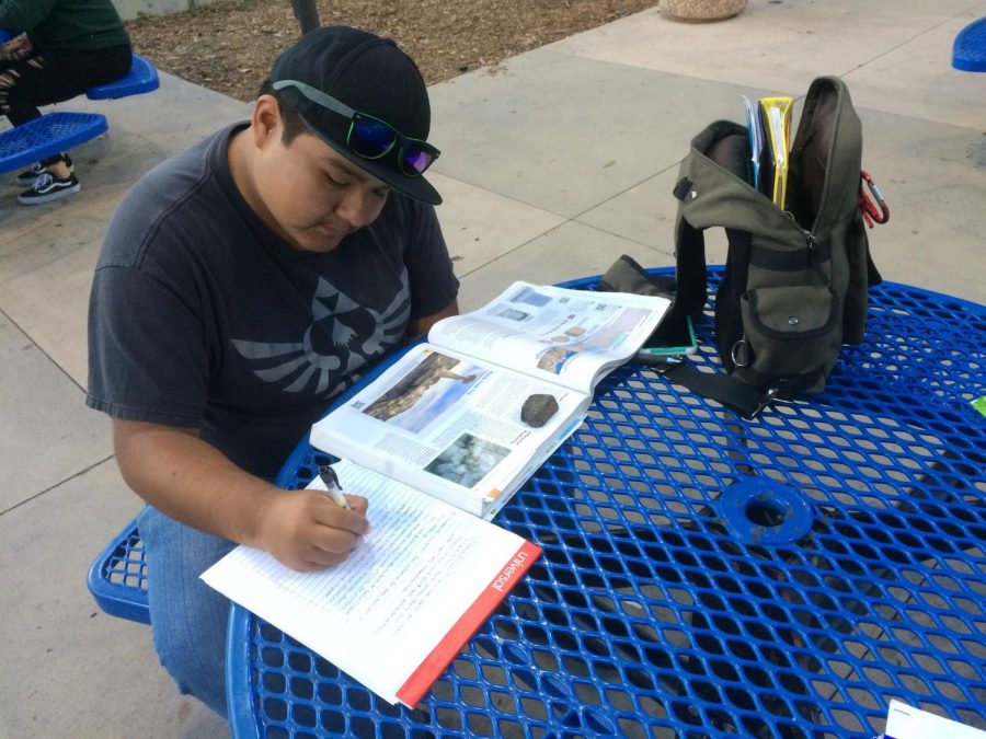 Student worker for the Special Resource Center, Eric Palma, 21, is busy near the Cafe Camino doing his academic work to succeed as a geology major. For now, what Im focusing on is just trying to get all my classes ready so that I can transfer,  Palma said. 