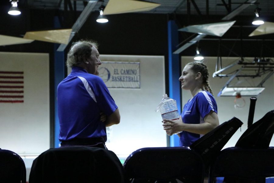 Warriors badminton coach John Britton and player Riley Arrowhead talking between matches versus East L.A. on Friday, March 29, at El Caminos North Gym. The Warriors have one last home game on Friday, April 5, versus Compton College. Photo credit: Anna Podshivalova