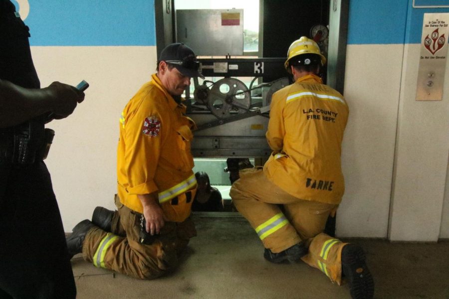 A Los Angeles County Fire Department firefighters attempt to rescue students stuck in an elevator on Monday, April 1. The students were stuck for five minutes. Photo credit: Rosemary Montalvo
