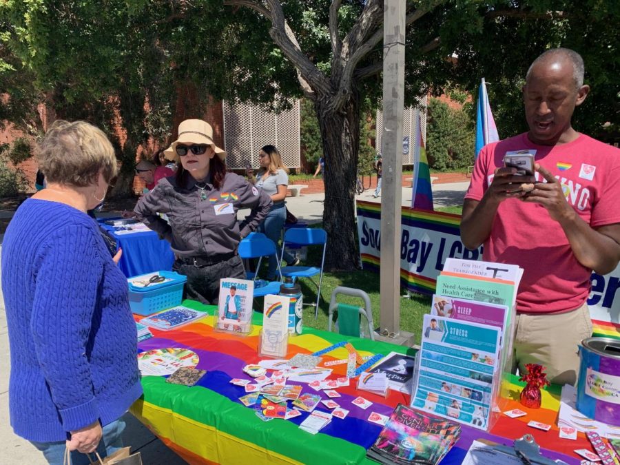 Linda Moore (left), 64, a former El Camino student visits the South Bay LGBTQ Center booth in support of the LGBTQ community during the Spring Health Fair on the Library Lawn on Tuesday, April 2. The South Bay LGBTQ Center provides education, support groups, and awareness about and to the LGBTQ community. The booth is ran by the president of the LGBTQ Center, Alphonzo Hicks (right) and Board Treasurer Mary Simun (middle). Photo credit: Rosemary Montalvo