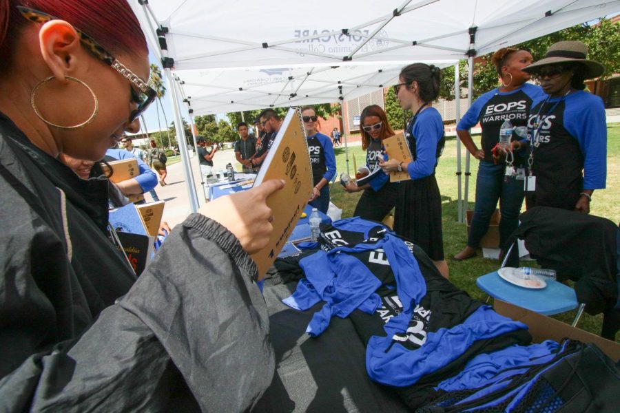 The EOPS booth gives out free school materials and gear to students at its 50 year celebration at the Library Lawn Thursday, Sept. 5. The event meant a lot for Assistant Director David Brown as he has a long history with the program, he said.  Rosemary Montalvo/The Union