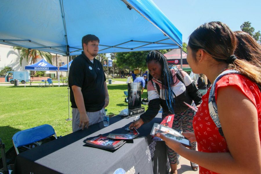 Universal Studios Corporate Sales Representative Austin Jacobs, 23, explains discounts that are offered to El Camino College students during the ASO Discount Fair at the Library Lawn on Wednesday, Oct. 4. Essentially every single one of our tickets you get discounts on as a student, he said. Jacobs said. Rosemary Montalvo/The Union