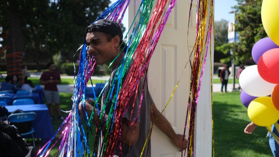 An ECC student walks through the coming out door during the National Coming Out Day event at the El Camino College Library Lawn on Thursday, Oct. 10. David Odusanya/The Union