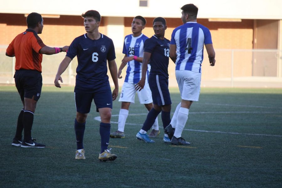 The referee talks to Cerritos and El Camino Colleges mens soccer team players after tensions flared during the game at the PE and Athletics Field on Friday, Oct.11. There were a total of 32 fouls recorded in the match. Viridiana Flores/ The Union