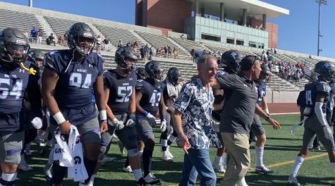 The El Camino College football team being led out by former head coach John Featherstone and current head coach Gifford Lindheim ahead of the regular season finale against Cerritos College at Murdock Stadium. Jose Tobar/The Union