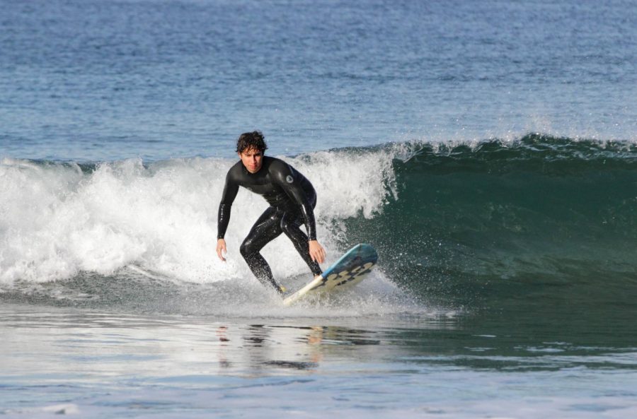 Giancarlo+Cotta%2C+21%2C+fire+and+emergency+technology+major%2C+one+of+surf+instructor+Kurt+Peters+students%2C+rides+in+front+of+a+wave+at+The+Strand+Friday%2C+Oct.11.+Peters+surfing+class+is+only+available+during+the+Fall+semester.+%E2%80%9CThere+is+just+something+about+being+in+the+water%2C+being+on+your+own%2C+you%E2%80%99re+out+there+with+your+own+thoughts+whether+you%E2%80%99re+surfing+with+friends+or+by+yourself%2C%E2%80%9D+Peters+said.+%0ARosemary+Montalvo%2FThe+Union