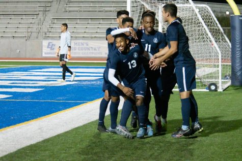 Players from the El Camino College mens soccer  team surround and cheer on Melvyn Perez-Cortez, No. 13, after he scored a goal against Orange Coast College in the 48th minute of the match at Murdock Stadium on Tuesday, Nov. 26. “At halftime we had a speech with the coach and he said to ‘come out strong’ and that’s what we did and it benefited us a lot and [the game] went in our favor,” Perez-Cortez said. Rosemary Montalvo/The Union
